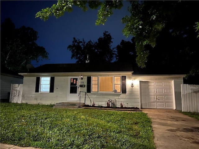 5921 Lexington Ave, Kansas City, MO 64123 - ranch-style home featuring an attached garage, driveway, and a lawn