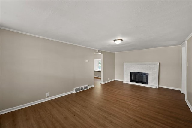813 S Hardy Ave, Independence, MO 64053 - unfurnished living room with dark wood finished floors, ornamental molding, and a fireplace