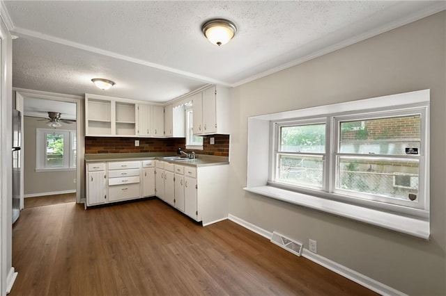 813 S Hardy Ave, Independence, MO 64053 - kitchen with a textured ceiling, backsplash, dark wood finished floors, crown molding, and open shelves