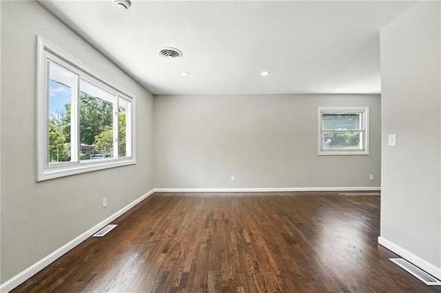 4916 N Manchester Ave, Kansas City, MO 64119 - unfurnished room featuring healthy amount of natural light, dark wood-style flooring, a smoke detector, and recessed lighting
