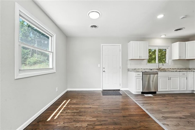 4916 N Manchester Ave, Kansas City, MO 64119 - kitchen with dishwasher, light stone countertops, white cabinets, and dark wood-style floors