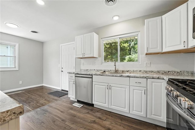 4916 N Manchester Ave, Kansas City, MO 64119 - kitchen featuring appliances with stainless steel finishes, healthy amount of natural light, backsplash, and recessed lighting