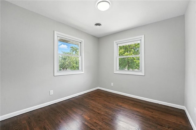 4916 N Manchester Ave, Kansas City, MO 64119 - empty room featuring plenty of natural light and dark wood-style flooring