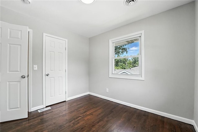 4916 N Manchester Ave, Kansas City, MO 64119 - unfurnished bedroom featuring baseboards and dark wood-style floors