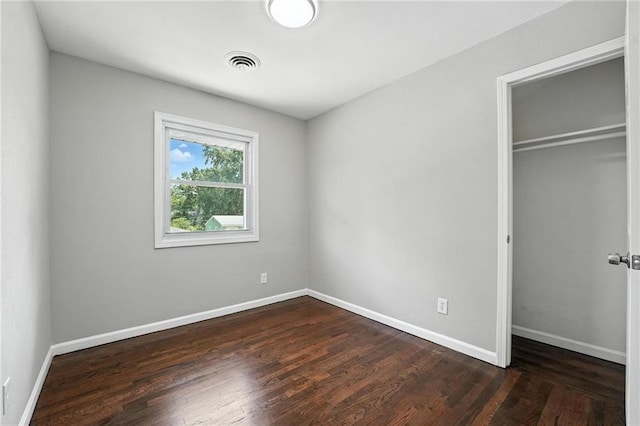 4916 N Manchester Ave, Kansas City, MO 64119 - unfurnished bedroom featuring a closet and dark wood-type flooring