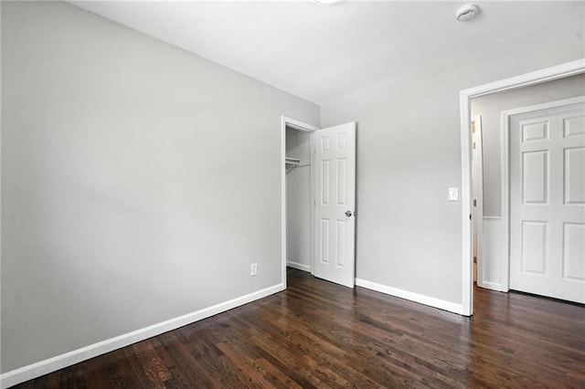 4916 N Manchester Ave, Kansas City, MO 64119 - unfurnished bedroom featuring dark wood-style flooring and a closet