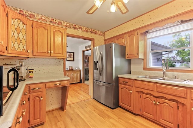 904 Leone Ave, Sedalia, MO 65301 - kitchen with stainless steel fridge with ice dispenser, light countertops, light wood-style floors, wallpapered walls, and ceiling fan