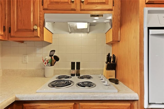 904 Leone Ave, Sedalia, MO 65301 - kitchen featuring ventilation hood, light countertops, white appliances, brown cabinets, and tasteful backsplash