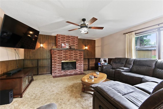 904 Leone Ave, Sedalia, MO 65301 - living area with wooden walls, ceiling fan, carpet, and a fireplace