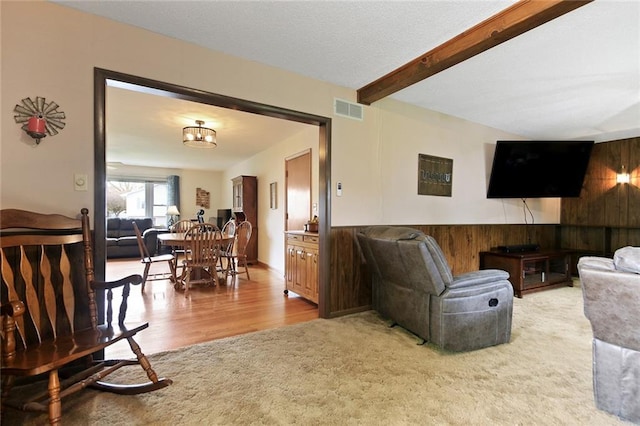 904 Leone Ave, Sedalia, MO 65301 - living area with wood walls, beamed ceiling, and wood finished floors