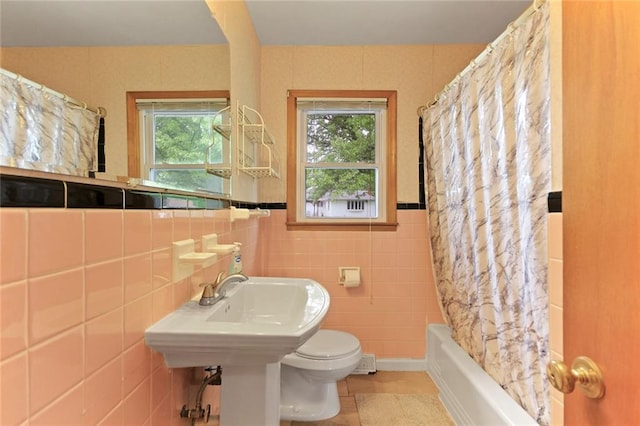 904 Leone Ave, Sedalia, MO 65301 - bathroom featuring tile walls, shower / tub combo with curtain, and tile patterned flooring