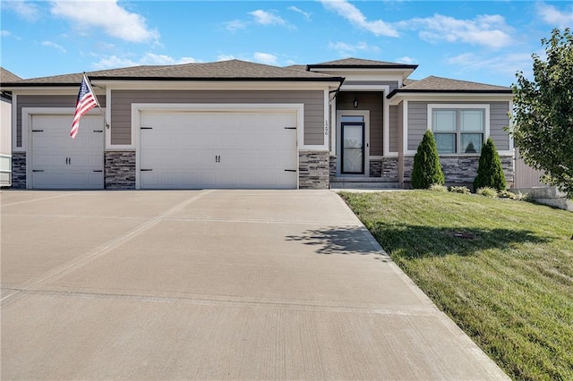 1296 NW Lindenwood Dr, Grain Valley, MO 64029 - prairie-style home with a garage, stone siding, concrete driveway, and a front lawn