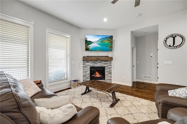 1296 NW Lindenwood Dr, Grain Valley, MO 64029 - living room featuring wood finished floors, ceiling fan, a stone fireplace, and recessed lighting