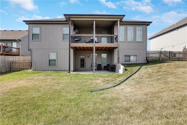 1296 NW Lindenwood Dr, Grain Valley, MO 64029 - rear view of house featuring a balcony, a fenced backyard, a patio, and a ceiling fan