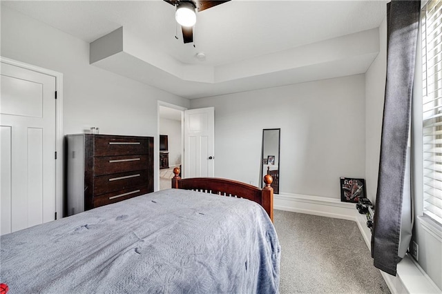 1296 NW Lindenwood Dr, Grain Valley, MO 64029 - bedroom featuring carpet, ceiling fan, and a tray ceiling