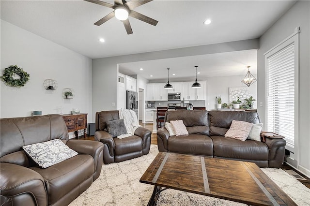 1296 NW Lindenwood Dr, Grain Valley, MO 64029 - living room with recessed lighting, ceiling fan, wood finished floors, and a chandelier