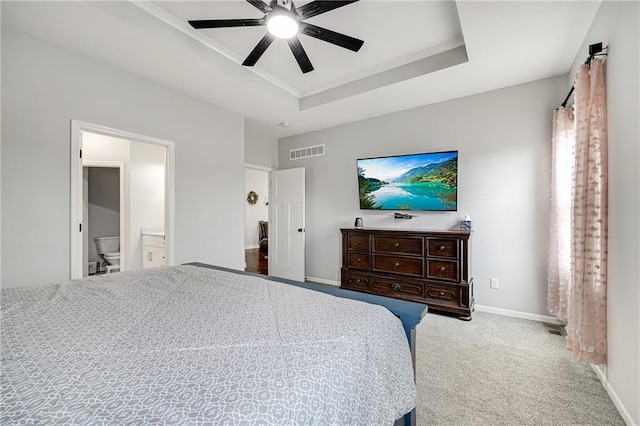 1296 NW Lindenwood Dr, Grain Valley, MO 64029 - bedroom featuring a raised ceiling, carpet flooring, connected bathroom, and ceiling fan