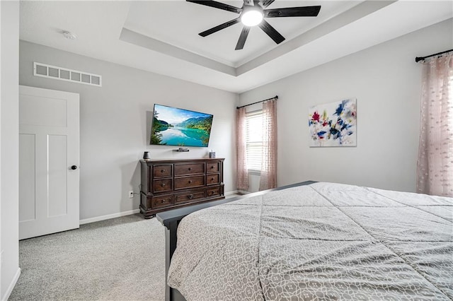 1296 NW Lindenwood Dr, Grain Valley, MO 64029 - carpeted bedroom with a raised ceiling and a ceiling fan