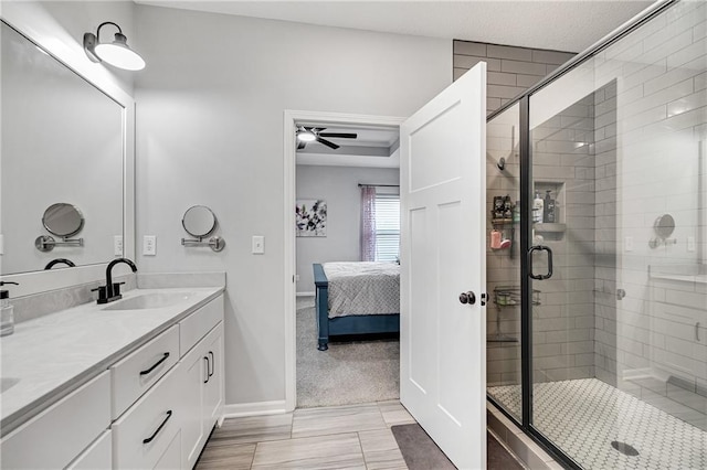 1296 NW Lindenwood Dr, Grain Valley, MO 64029 - bathroom featuring ensuite bathroom, double vanity, a shower stall, and a ceiling fan