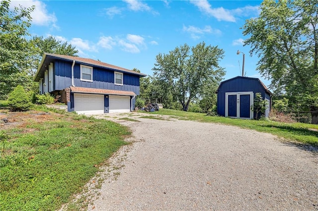 4252 SE Valleyview Ln, Holt, MO 64048 - view of front of property featuring dirt driveway, board and batten siding, a garage, and a storage unit