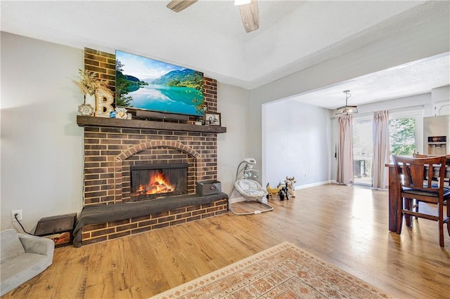 4252 SE Valleyview Ln, Holt, MO 64048 - living room with wood finished floors, a fireplace, and a ceiling fan