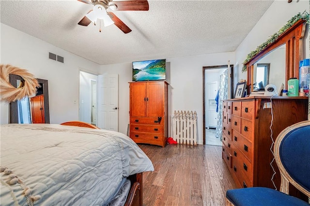 4252 SE Valleyview Ln, Holt, MO 64048 - bedroom featuring a textured ceiling, hardwood / wood-style floors, radiator, and ceiling fan