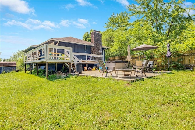 4252 SE Valleyview Ln, Holt, MO 64048 - rear view of house with board and batten siding, a patio area, a deck, a hot tub, and a chimney