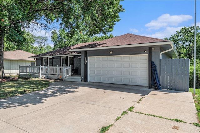 2518 Arrowhead Rd, Topeka, KS 66614 - single story home featuring concrete driveway, an attached garage, a shingled roof, and a porch