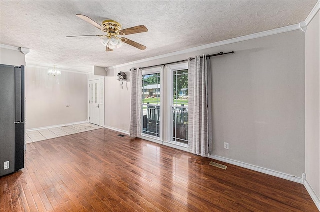 2518 Arrowhead Rd, Topeka, KS 66614 - spare room featuring hardwood / wood-style floors, ceiling fan, a chandelier, a textured ceiling, and crown molding