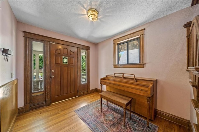 362 S 10th St, Kansas City, KS 66102 - entryway with light wood finished floors and a textured ceiling