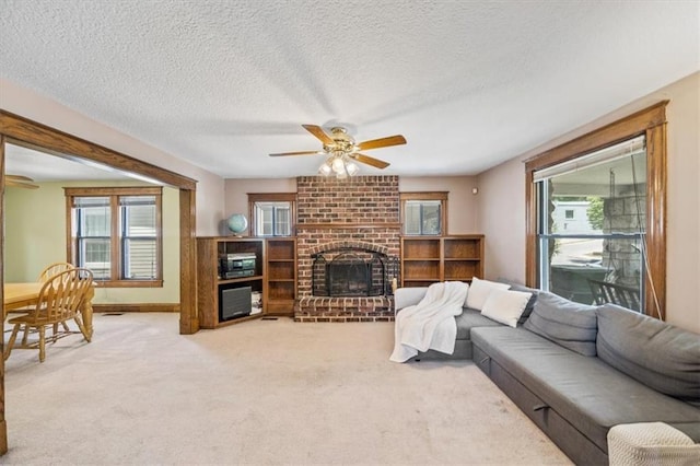 362 S 10th St, Kansas City, KS 66102 - living area featuring light carpet, a brick fireplace, ceiling fan, and a textured ceiling