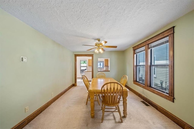 362 S 10th St, Kansas City, KS 66102 - dining space with light colored carpet, healthy amount of natural light, a ceiling fan, and a textured ceiling