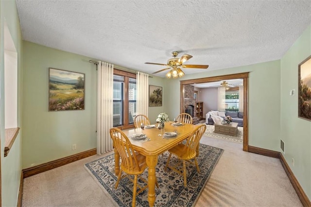 362 S 10th St, Kansas City, KS 66102 - dining area featuring ceiling fan, healthy amount of natural light, light colored carpet, and a textured ceiling