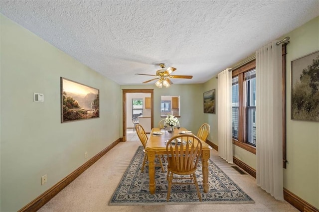 362 S 10th St, Kansas City, KS 66102 - dining area with light colored carpet, plenty of natural light, a textured ceiling, and a ceiling fan