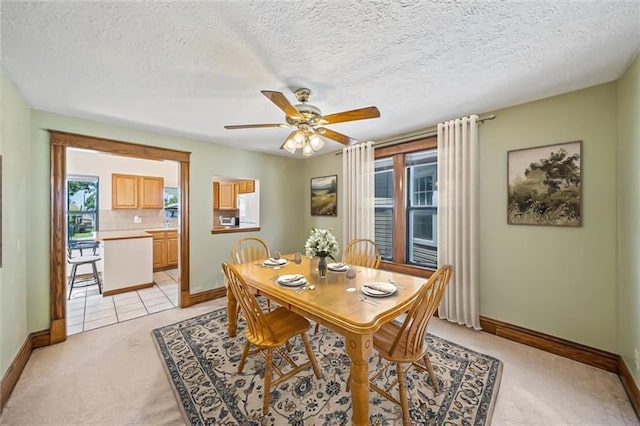 362 S 10th St, Kansas City, KS 66102 - dining space with light carpet, a ceiling fan, and a textured ceiling