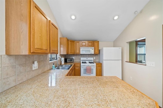 362 S 10th St, Kansas City, KS 66102 - kitchen featuring white appliances, vaulted ceiling, tile countertops, tasteful backsplash, and recessed lighting