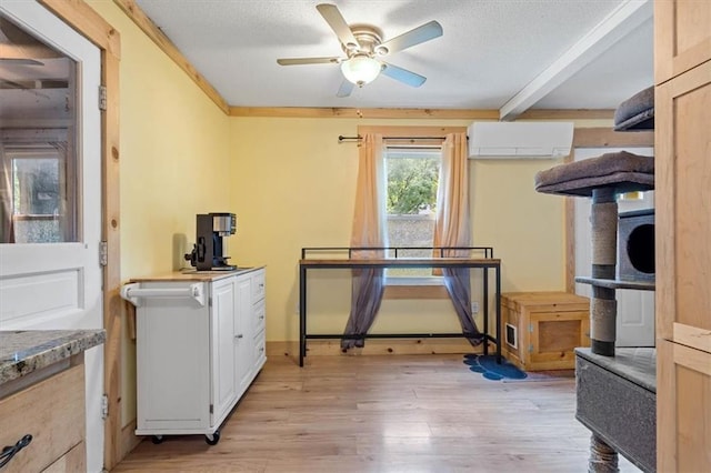 733 S Chestnut St, Olathe, KS 66061 - interior space featuring a wall mounted AC, light wood-style flooring, a textured ceiling, a ceiling fan, and beamed ceiling