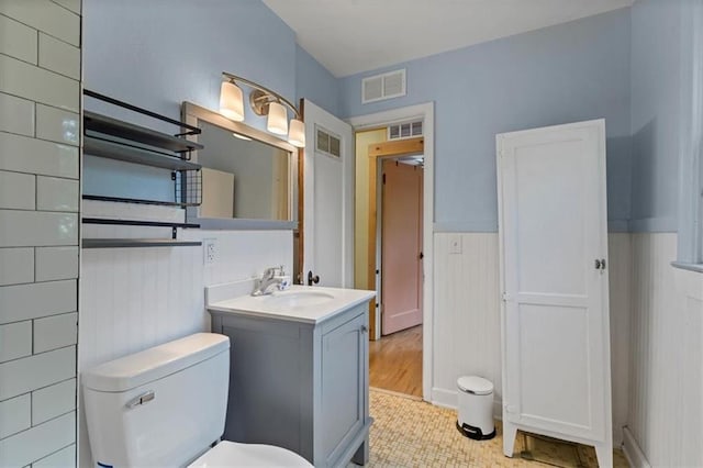 733 S Chestnut St, Olathe, KS 66061 - bathroom with vanity, a wainscoted wall, and tile patterned floors