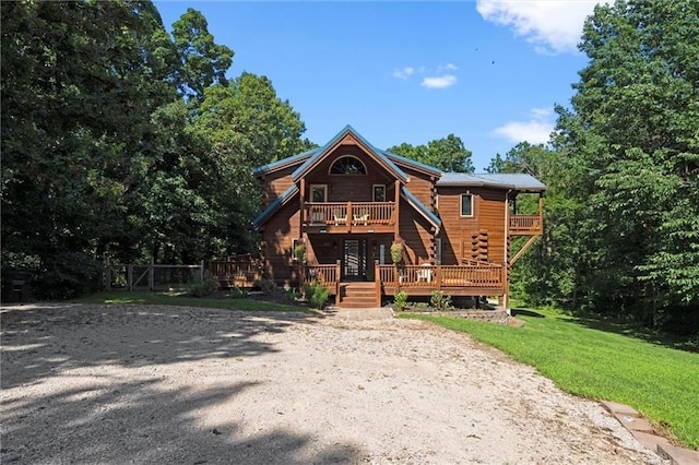 389 NW 1851st Rd, Kingsville, MO 64061 - cabin with a front yard, gravel driveway, and a deck