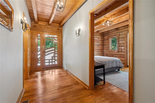 389 NW 1851st Rd, Kingsville, MO 64061 - foyer entrance featuring a wooden ceiling with exposed beams, wood walls, and wood-type flooring