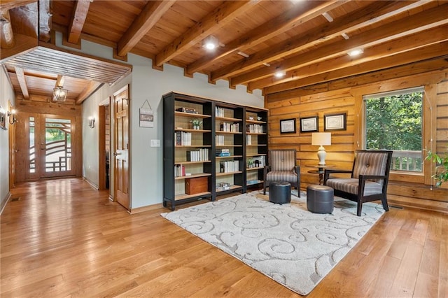 389 NW 1851st Rd, Kingsville, MO 64061 - sitting room featuring a wooden ceiling with exposed beams, healthy amount of natural light, light wood-style flooring, and wood walls