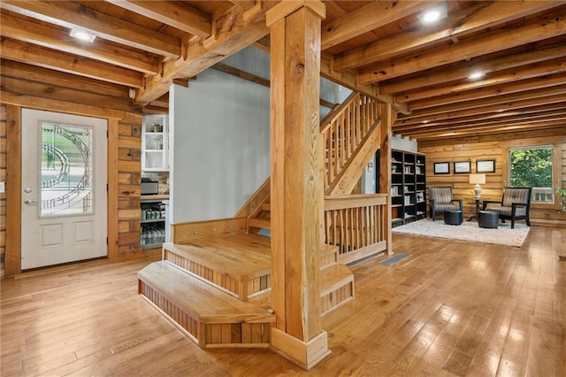 389 NW 1851st Rd, Kingsville, MO 64061 - entryway featuring stairway, wood-type flooring, wooden walls, and a wooden ceiling with exposed beams
