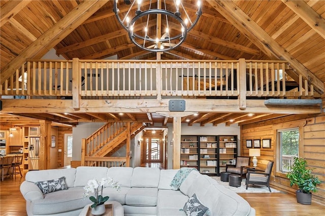 389 NW 1851st Rd, Kingsville, MO 64061 - living area featuring a wood ceiling with exposed beams, hardwood / wood-style floors, a chandelier, wood walls, and high vaulted ceiling
