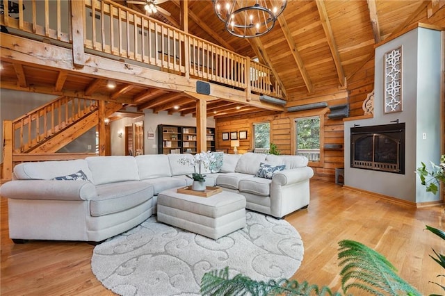 389 NW 1851st Rd, Kingsville, MO 64061 - living room featuring a wooden ceiling with exposed beams, wood finished floors, stairs, a chandelier, and high vaulted ceiling