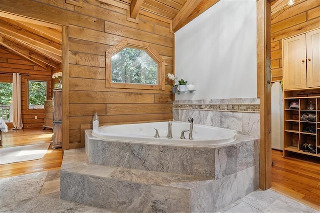 389 NW 1851st Rd, Kingsville, MO 64061 - bathroom featuring vaulted ceiling, wooden ceiling, wooden walls, a garden tub, and wood finished floors