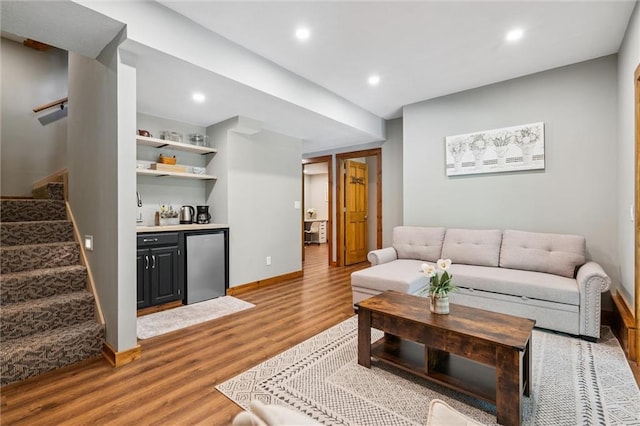 389 NW 1851st Rd, Kingsville, MO 64061 - living area featuring stairs, wood finished floors, bar, and recessed lighting
