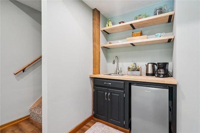 389 NW 1851st Rd, Kingsville, MO 64061 - indoor wet bar with freestanding refrigerator and wood finished floors