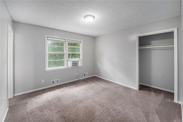 12731 Byars Rd, Grandview, MO 64030 - unfurnished bedroom featuring a textured ceiling, carpet, a closet, and cooling unit