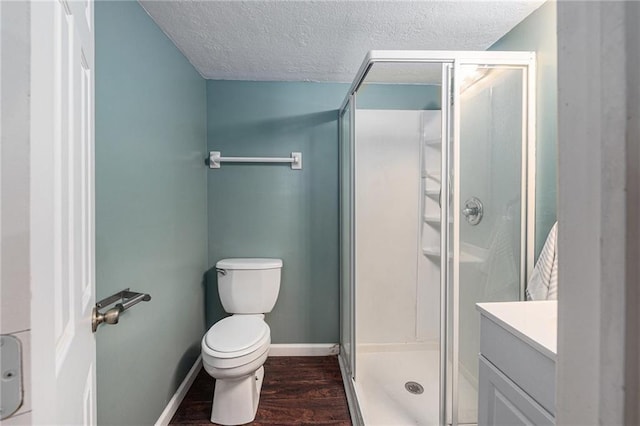 12731 Byars Rd, Grandview, MO 64030 - full bathroom featuring wood finished floors, a stall shower, a textured ceiling, and vanity