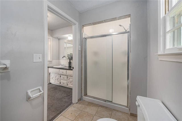 12731 Byars Rd, Grandview, MO 64030 - full bath with a shower stall, vanity, tile patterned floors, and a textured ceiling